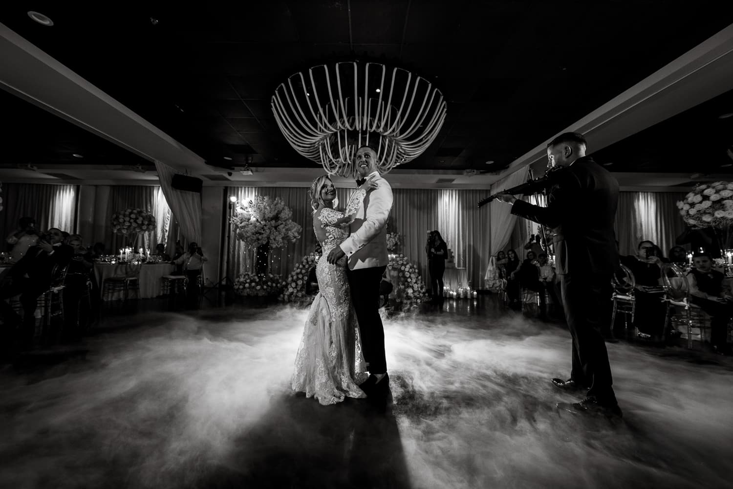 First dance beneath the chandelier with a live violinist