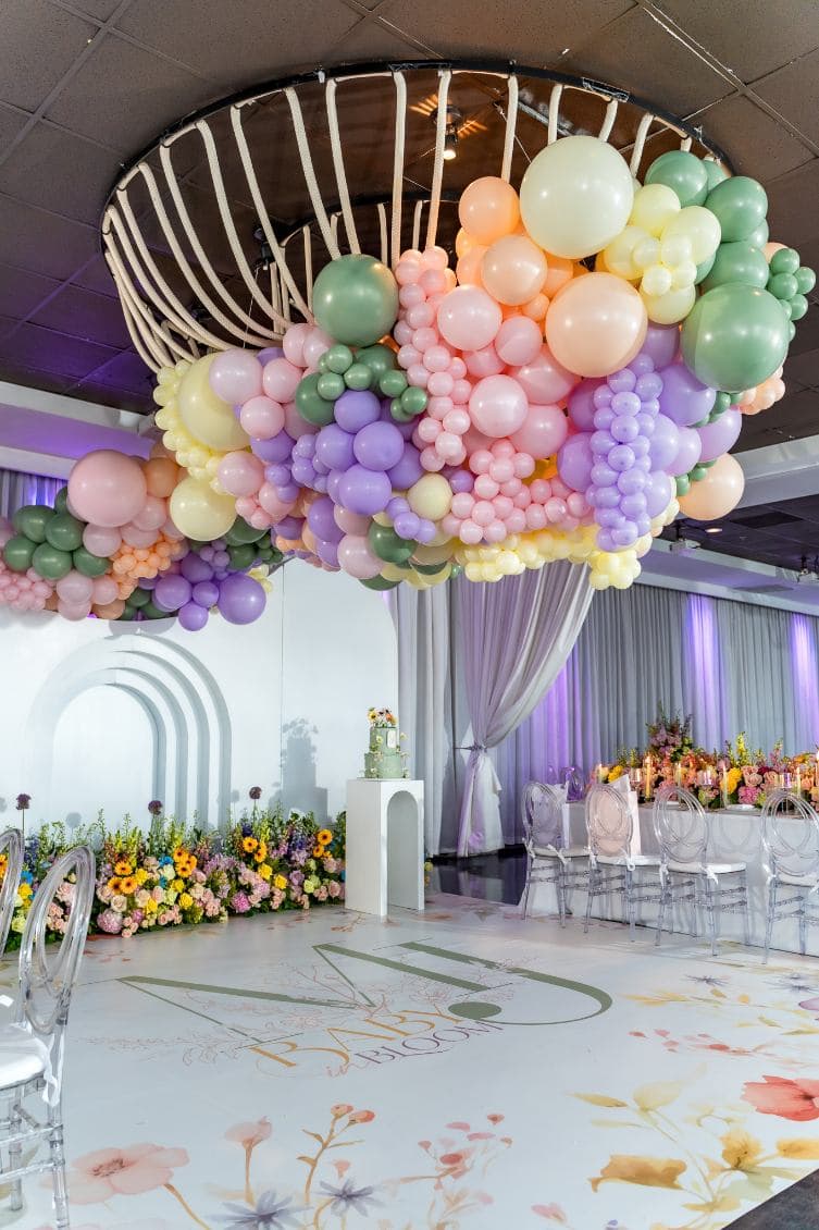 Baby shower with a pastel balloon installation cascading from the chandelier